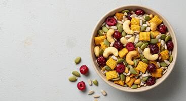 Overhead view of a colorful, healthy snack bowl filled with nuts, seeds and dried cranberries. photo