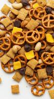 An appetizing assortment of crunchy pretzels, crackers, nuts, and chocolate pieces. photo