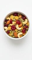 A delightful bowl of trail mix, showcasing a mix of nuts, seeds, and dried cranberries. photo