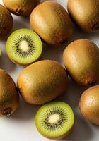 A top-down view of multiple kiwis, some whole and some sliced, showcasing their freshness. photo
