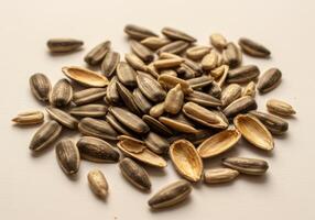 A detailed view of a pile of sunflower seeds, showing the textures and the shells. photo