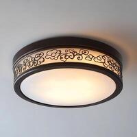 Elegant ceiling light with intricate cloud pattern illuminates a modern room, enhancing interior design with its warm glow and sophisticated aesthetic appeal, casting light. photo