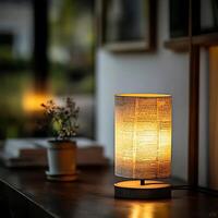 Illuminated newspaper print table lamp casting a warm glow in a cozy interior setting, showcasing vintage design and creating a tranquil atmosphere with decorative plant and soft background lighting. photo