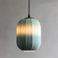 Elegant blue pendant light casting soft light with fluted design, creating a warm ambiance and modern aesthetic suspended from the ceiling photo