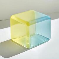 Translucent Cube Object Casting Shadow on White Surface, Modern Design and Abstract Art, Transparent Geometric Shape with Yellow and Blue Gradient, Minimalist Still Life photo