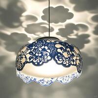 Decorative blue and white patterned pendant light casting playful cloud shadows on ceiling creates a whimsical and artistic ambiance illuminating the space with soft light and whimsical design photo
