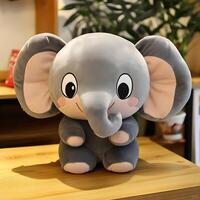 Adorable plush elephant toy sitting upright on a wooden table indoors bringing joy and comfort with its charming design making it a perfect companion for children and collectors alike photo