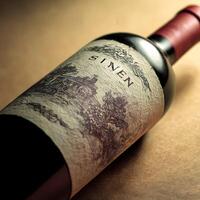 A close up view of a sinen wine bottle with an intricate label design photo
