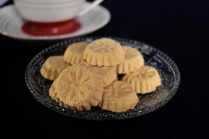 Close up view of kue satu or kue koya, a popular dry traditional cookie commonly found in Java, made of sweet mung bean powder that crumbles when bitten. photo