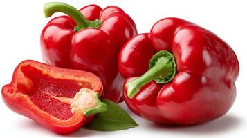 2 Plump Red Bell Peppers and Half on White Background photo