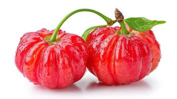2 Ripe Red Acerola Cherries with Water Droplets on White Background photo