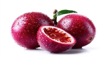 2 Whole and 1 Halved Juicy Purple Passionfruit with Water Droplets on White Background photo