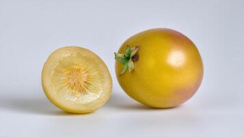 Bright Yellow Passionfruit Halved on White Background photo