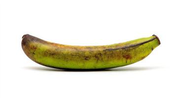 Close up of an Overripe Green Plantain with Brown Spots on White Background photo