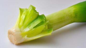 Closeup of a Fresh Green Scallion on White Background photo