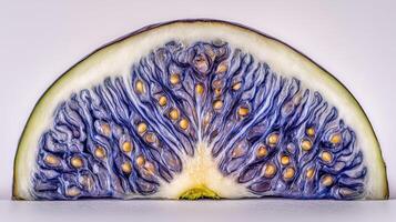 Closeup of a Sliced Purple Fig with Visible Seeds on White Background photo