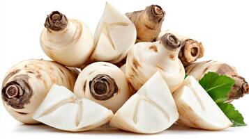 Closeup of Fresh White Jicama Slices and Whole Roots on White Background photo