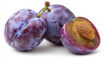 Ripe Purple Plums Sliced and Whole on White Background photo