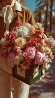 Beautiful bouquet of fresh flowers held by a person in stylish attire in a sunny outdoor location photo