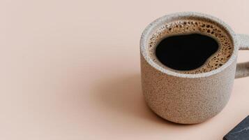 Closeup of Speckled Beige Coffee Cup on Peach Background photo