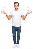 Joyful Young Man Juggling Three White Balls Against White Background photo