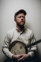 Portrait of a Bearded Man in Beige Shirt Holding a Banjo Against a Gray Background photo