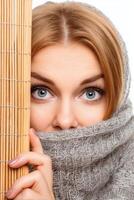 Portrait of a Woman Partially Hidden Behind a Gray Scarf and Bamboo Mat photo