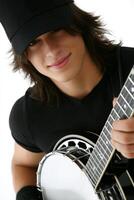 Smiling Young Man with Long Brown Hair Playing Banjo, Close up Portrait photo