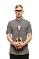 Young Blond Man in Black and White Shirt Holding Ukulele Studio Portrait photo