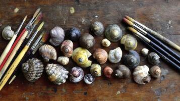 Artistic Arrangement Shells and Paintbrushes on Aged Wooden Surface photo