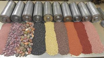 Assorted Tumbled Stones and Rock Polishing Supplies on a Table photo