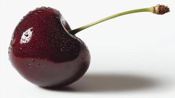 A cherry is shown with water droplets on it photo