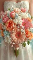 Beautiful bridal bouquet featuring peach and pink flowers arranged with delicate greenery for a wedding celebration photo