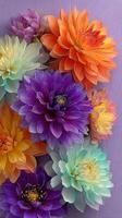 Colorful display of various flowers creating a vibrant wall decoration in bright shades of purple, orange, and blue photo