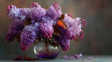 Colorful lilac flowers arranged in a glass vase on a wooden table against a soft background photo