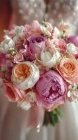 Beautiful bouquet featuring peonies, roses, and seasonal flowers for a wedding ceremony in bright natural light photo