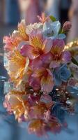 Beautiful bouquet of pink and blue flowers resting on a reflective surface with water droplets during a sunny event photo