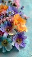 Colorful spring bouquet arrangement with various flowers on a blue background photo