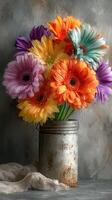 Colorful gerbera daisies arranged in a rustic vase on a textured background in a soft light photo