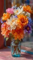 Colorful flower bouquet in a glass vase brightening a sunny window ledge in a cozy space photo