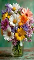 Bright flower bouquet in glass vase with diverse blooms arranged for decorative display in warm light photo
