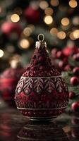 Decorative red Christmas ornament with intricate details sparkling against a blurred festive background photo