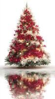 Colorful Christmas tree decorated for the holiday season with lights and ornaments reflecting on the ground photo