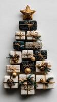 Unique Christmas tree made from decorative gift boxes arranged creatively on a neutral background photo
