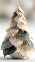 Decorative ceramic tree with gold accents and intricate leaf details displayed indoors photo