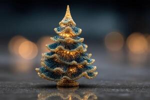 Miniature Christmas tree decorated with lights set on a reflective surface during the holiday season photo