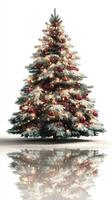 Beautifully decorated Christmas tree with ornaments and lights reflecting on a white surface in a festive setting photo