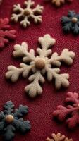 Colorful embroidered snowflakes on deep red fabric create a vibrant textile design for winter decor photo