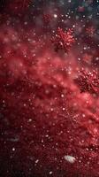 Red and white snowflakes gently fall on a festive background creating a winter wonderland atmosphere photo