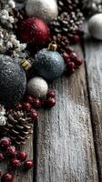 Elegant decorations featuring Christmas ornaments and pinecones on rustic wooden background for festive ambiance photo